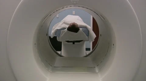 Man getting medical Pet scan done in hospital for cancer screening Stock Footage
