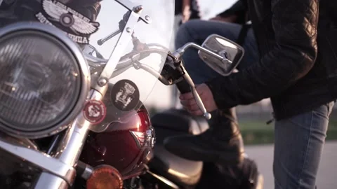 A man is getting on a motorcycle Video stock 233966156