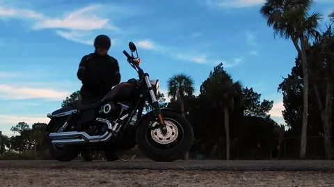 Man getting on motorcycle/riding off Vídeos de archivo 45248635