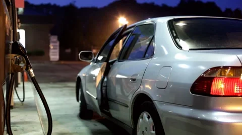 Man getting out of car and pumping gas Vídeos de archivo 7727868