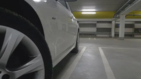 Man getting out of a car parked in a garage Stock Footage 85402777