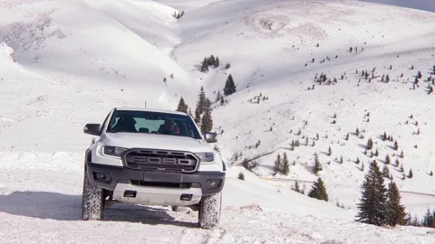 Man getting out of a Ford Ranger Rapto pickup truck parked on the mountain top Stock Footage 169946481