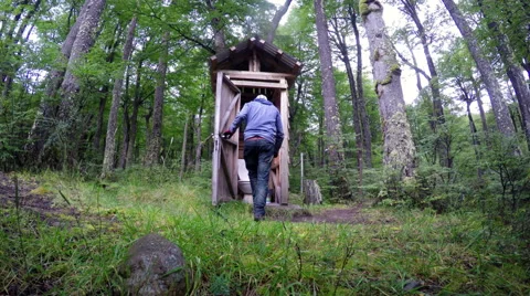 Man getting into OutHouse 4K Stock Footage 49920752