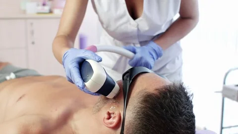 Man getting permanent laser face hair removal Stock Footage 78507469
