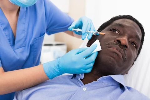 Man getting procedure of injection for face skin tightening Stock Photos