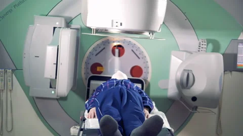 A man is getting radiated by a linear accelerator Stock-Footage 93413581