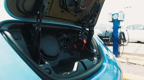 Man getting ready to charge his electric car Stock Footage 65681756
