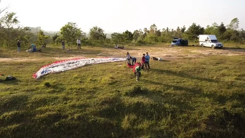Man getting ready to paraglide off a cliff in Phetchabun Thailand Stock Footage 98473439