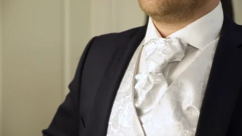 Man getting ready for a wedding, Norway, adjusting his tie Video stock 84208958