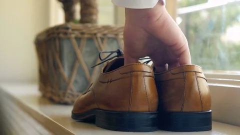 Man getting ready for a wedding, Norway, taking shoes Stock Footage 84209053