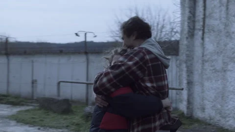 Man getting released from jail and hugging his wife Stock Footage 283094289