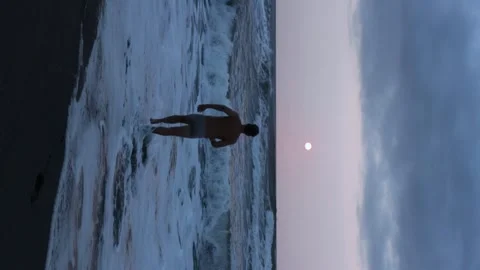 Man getting into the sea water Stock Footage 246861244