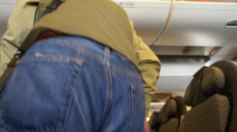 Man getting seating on Airplane - Wide Angle Video stock 1048676