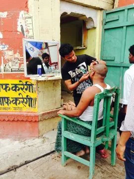 A Man Getting Shaved on the street of India Stock Photos