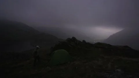A man getting into a tent at night in the mountains 스톡 동영상 140755482