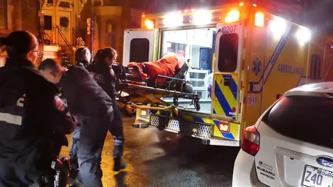 Man getting transported in ambulance Stock Footage 102001266