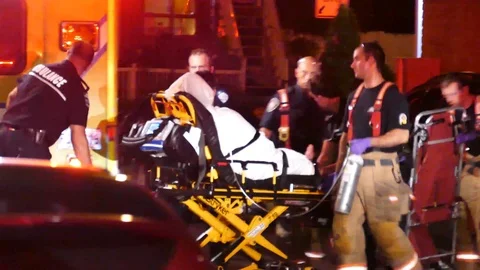 Man getting transported by EMS after stabbing Stock Footage 99848138