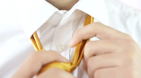 Man getting undressed untying a yellow tie for relaxation. Stock Footage