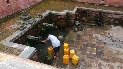 Man getting water at one of the dharas in Kathmandu 스톡 동영상 206074174