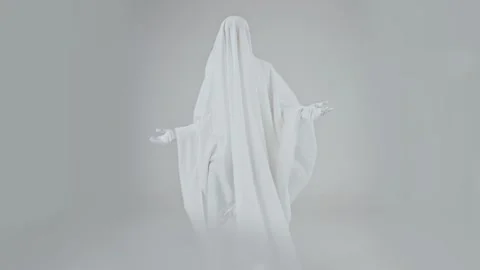 Man in ghost costume with white sheet dancing on white background. Stock Footage 287915488