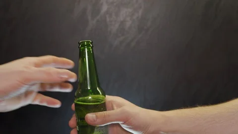 Man gives a bottle of beer Stock Footage 102918692