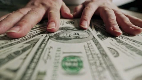 A man gives a bribe. U.S. dollars close-up on the table. Two hands on top of the Видео 221611166