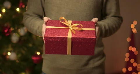 Man gives a christmas present Stock Footage 143837533
