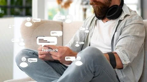 Man gives feedback while seated on a couch in a modern living room Stock Photos