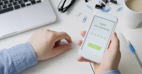 Man gives five star rating using smartphone application Stock Footage 78502081