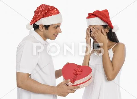 Man giving a Christmas present to his girlfriend Stock Photos