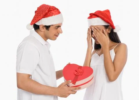 Man giving a Christmas present to his girlfriend Stock Photos