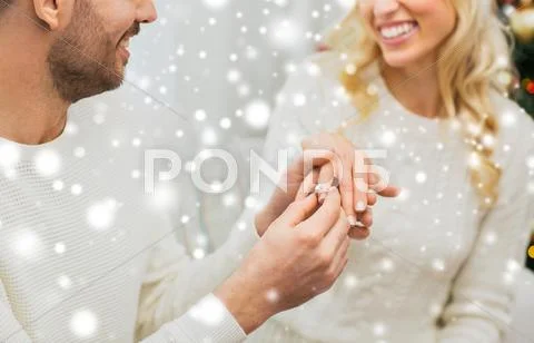 Man giving diamond ring to woman for christmas Stock Photos