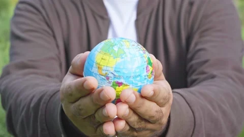 A man is giving up a globe mockup into camera. World environment day concept.4K  Stock Footage 145177645