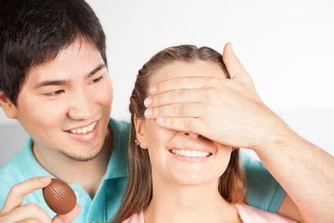 Man giving to her girlfriend a easter eggs Stock Photos