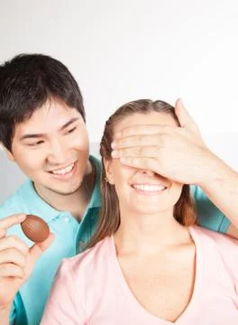 Man giving to her girlfriend a easter eggs Stock Photos