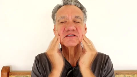 Man giving himself a face Massaging Stock Footage 169193372