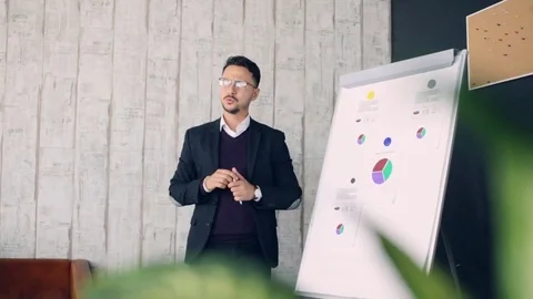 Man Giving Presentation to her Colleagues During a Meeting Stock Footage 83609082