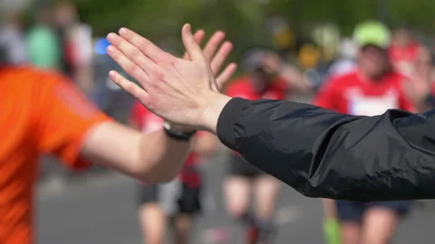 Man giving runners high five in 4k slow motion 60fps Stock-Footage 93434437