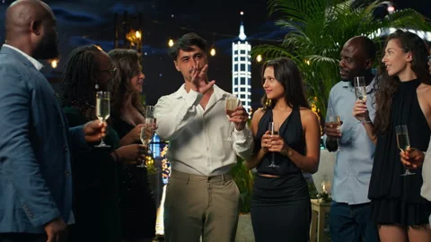 Man giving speech for party guests at night, toasting with champagne Stock Footage 346781940