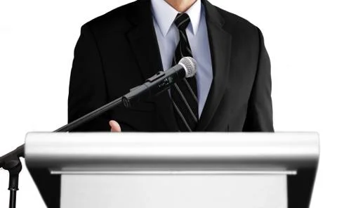 Man giving speech using microphone on stage Stock Photos