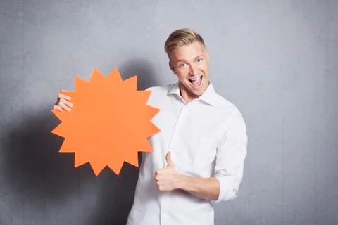 Man giving thumbs up at blank panel promoting sales. Stock Photos