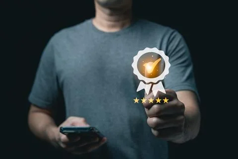 Man giving thumbs up with virtual five star rating and quality assurance ba.. Stock-Fotos