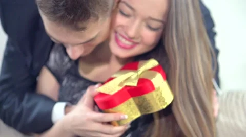 Man giving a Valentine's gift to Girlfriend. Couple with Valentine's present Stock Footage