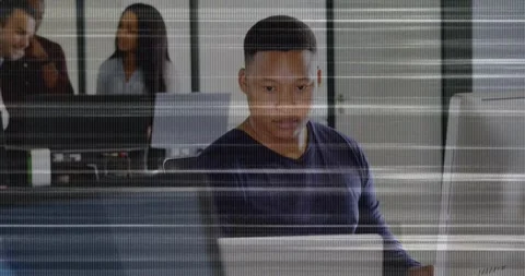 Man glancing right, reaching phone, switching to laptop, checking office data Stock Footage 329786528