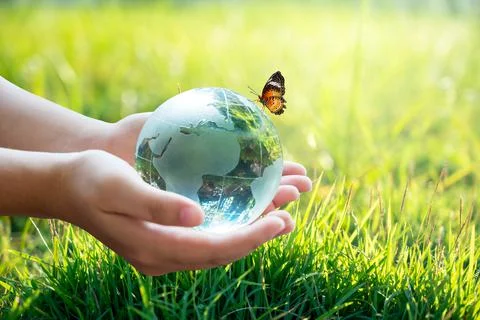 A man with a glass globe Concept day earth Save the world save environment Th Stock Photos