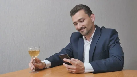 Man with a glass of wine online Stock Footage 77809244