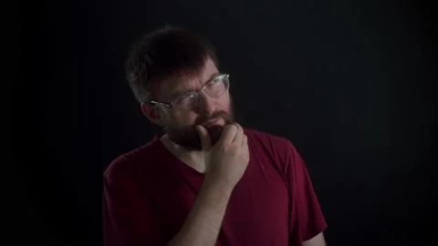 A man with glasses and a beard thought about something. 库存影片 169667766