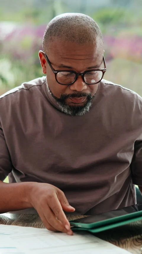 Man, glasses and research with tablet in home, financial analyst and risk Stock Footage 335785100