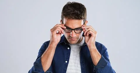 Man, glasses and touch in studio for vision, optometry or adjusting to new lens Stock Photos