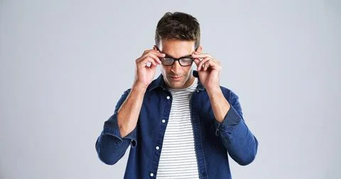 Man, glasses and touch in studio for optometry, vision or adjusting to new lens Stock Photos